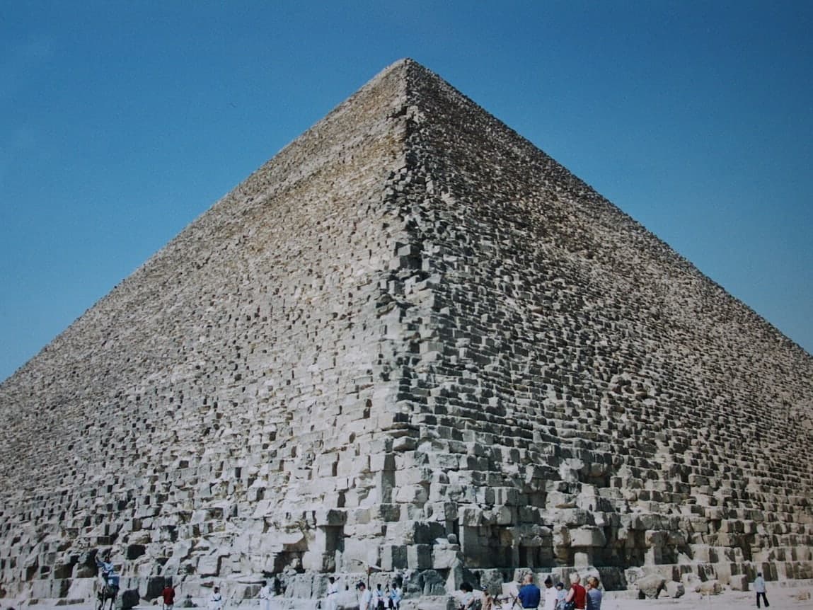 The Great Pyramid of Khufu at Giza, photographed in daylight with the desert plateau in front.