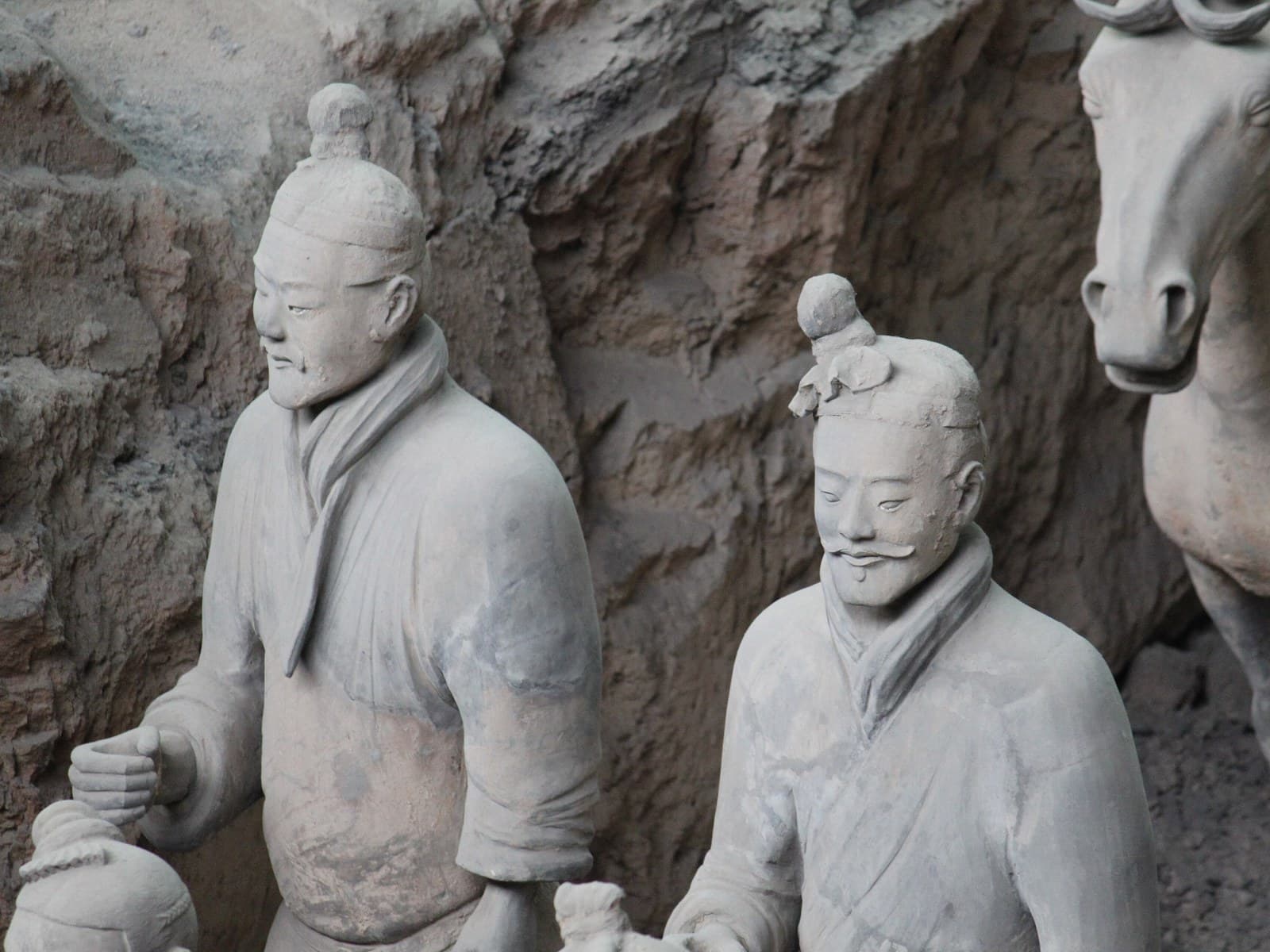 Terracotta Army soldiers and a horse standing in the excavated earth of Pit 1, near the tomb of Qin Shi Huang.