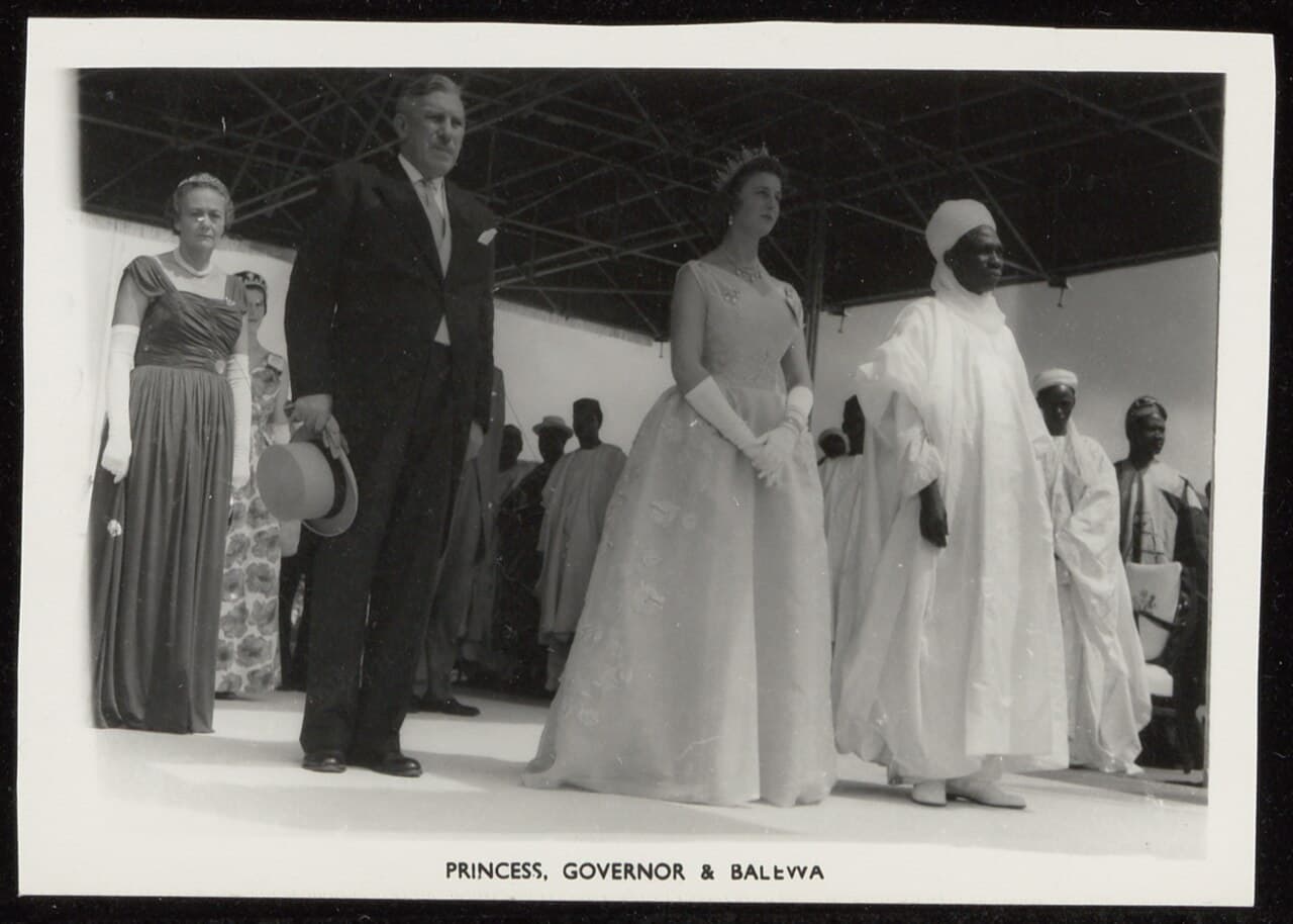 Black-and-white photograph of Sir James Robertson, Princess Alexandra, and Abubakar Tafawa Balewa standing under a canopy at the Nigerian independence ceremony in Lagos, 1 October 1960.